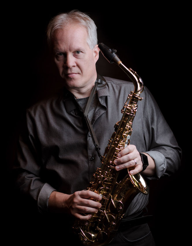 Kirk O'Riordan holding a saxophone