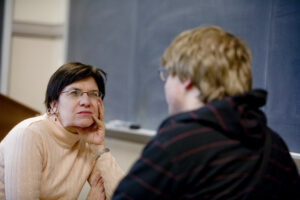 Lee Upton listens to a student in class.