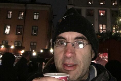 Justin Corvino holds a cup of mulled cider at the famous Christmas Market in the Old Town in Stockholm.