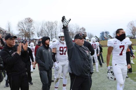 Gene Palmasano raises a hand on the sidelines during a Lafayette College football game.