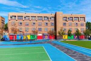A New York City School with a playing field in front of it