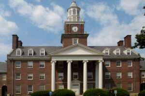 An exterior view of Watson Hall, a brick building with four pillars in the front