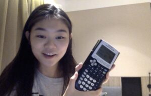 A student holds a calculator.