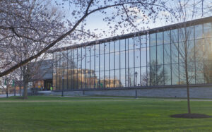 Skillman Library in spring with cherry blossoms in front of it