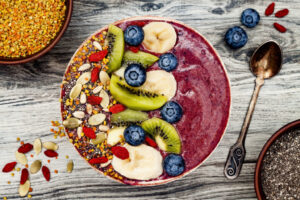 A bowl of fruit, nuts, and grains