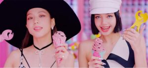 Two women hold ice cream cones in a music video.