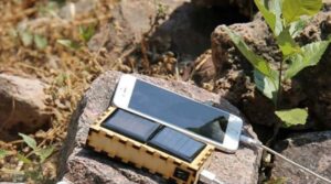A cell phone in the sun with a solar charger