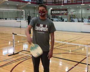  Charlie Leroux holds his pickleball paddle.