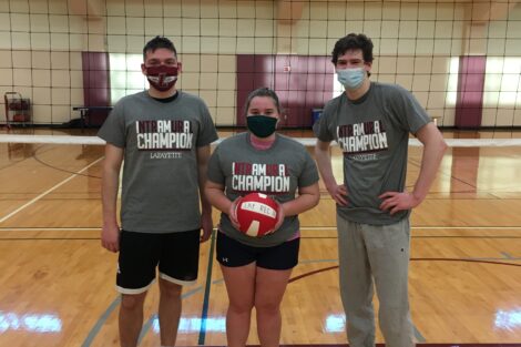 Three students pose for a photo after winning their intramural volleyball match.