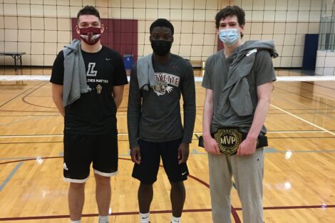 Three students pose for a photo after winning their intramural volleyball match.