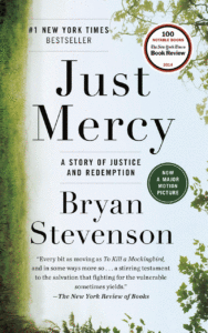 The cover of Just Mercy by Bryan Stevenson, with green grass and leaves