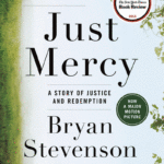 The cover of the book Just Mercy by Bryan Stevenson, mostly text and some tree branches with green leaves