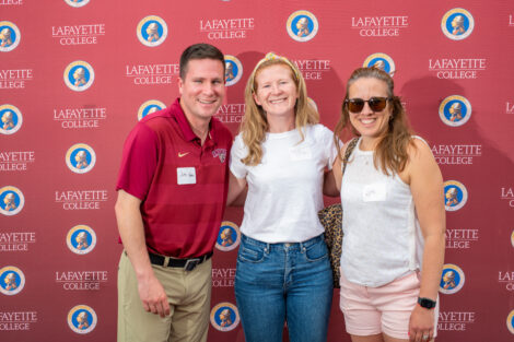 Kaity McKittrick and two other employees pose in front of the Lafayette-branded backdrop at the conclusion of the faculty-staff awards event at Fisher Stadium