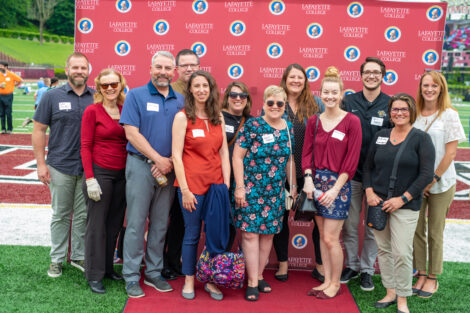 Development staff pose in front of the Lafayette-branded backdrop at the conclusion of the faculty-staff awards event at Fisher Stadium.