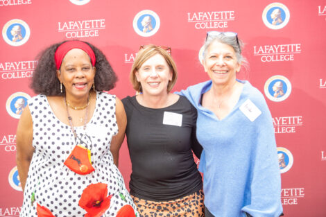 Alma Buczak, Lisa Rex, and Leslie Muhlfelder pose in front of the Lafayette-branded backdrop at the conclusion of the faculty-staff awards event at Fisher Stadium