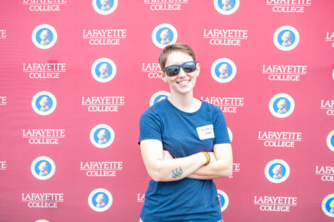 Melissa Ash poses in front of the Lafayette-branded backdrop at the conclusion of the faculty-staff awards event at Fisher Stadium