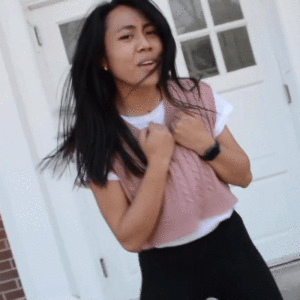 Kimberly Manalang dances in front of a door in her music video.