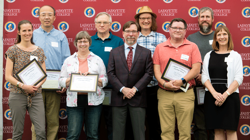 Seven laboratory professionals along with John Meier and President Alison Byerly