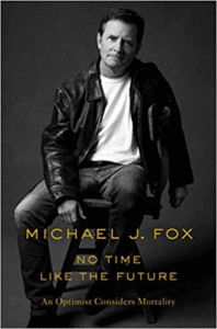 The cover of No Time Like the Future, with Michael J. Fox in a black-and-white photo sitting with a white shirt and black jacket, looking serious