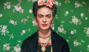 Frida Kahlo wearing a black jacket with flowers in her hair