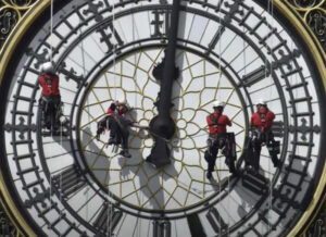 Four men work on the Big Ben clock in London.