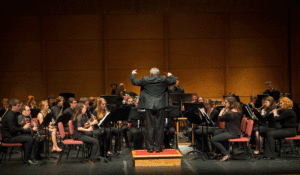 Kirk O'Riordan conducts the student Concert Band on the Williams Center stage in 2014.