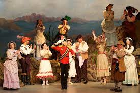 Thirteen members of New York Gilbert and Sullivan Players in period costume perform a scene from Pirates of Penzance.