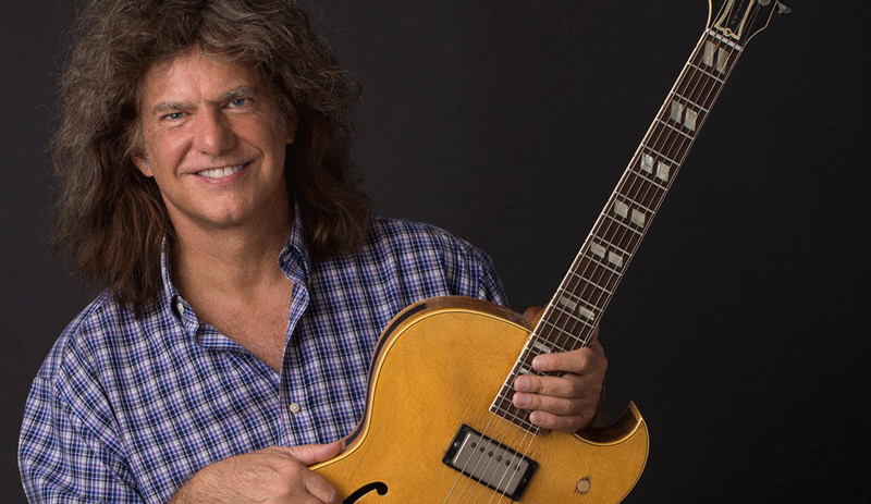 Pat Metheny holds his guitar