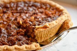 Photo of a piece being removed from a pecan pie. Photo by Keighla Exum.