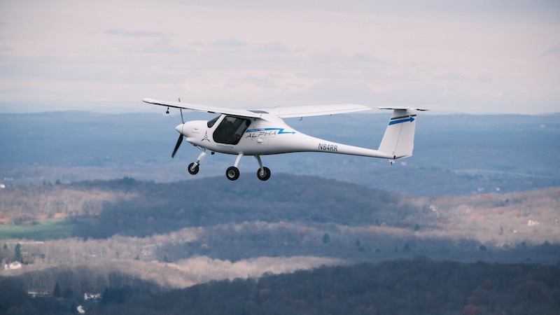 Electric plane is shown mid-flight in the air.