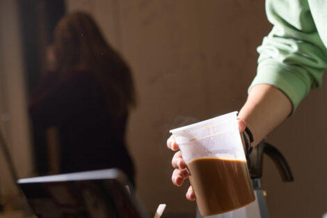 A student holds a container of ground coffee during Professor Joseph Woo’s FYS143 Coffee Showcase.