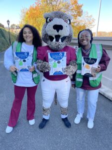 Two Lafayette student eco-reps stand with the Lafayette leopard to highlight proper recycling signs