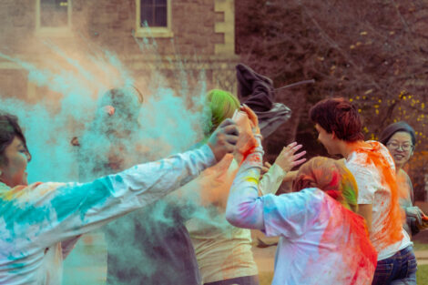 Students throw colorful powder during Holi Fest 2023