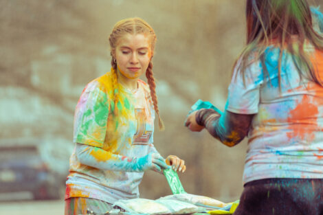 Students get covered in colorful powder during Holi Fest.