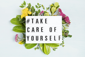 flowers with #take care of yourself text on top