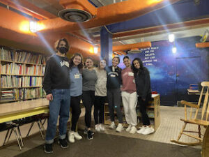 Seven students cleaned, organized, and prepared the Amanda Miner Library at Third Street Alliance. Pictured from left to right: Owen Baute '26, Caroline Hugo '25, Grace Comfort '25, Grace Stubblefield '24, Kate Konigsberg '25, Rachel Kass '25, and Kira Raison '25.