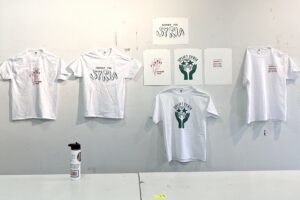 Four t-shirts and four posters are displayed as part of a fundraiser for the victims of Turkey/Syria earthquakes.
