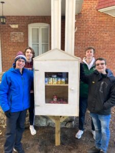 Four students stand with the micro food pantry they built for Cornerstone Church in Easton, Pa.