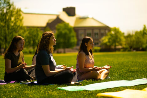 Students participate in a mindfulness exercise on the Quad.