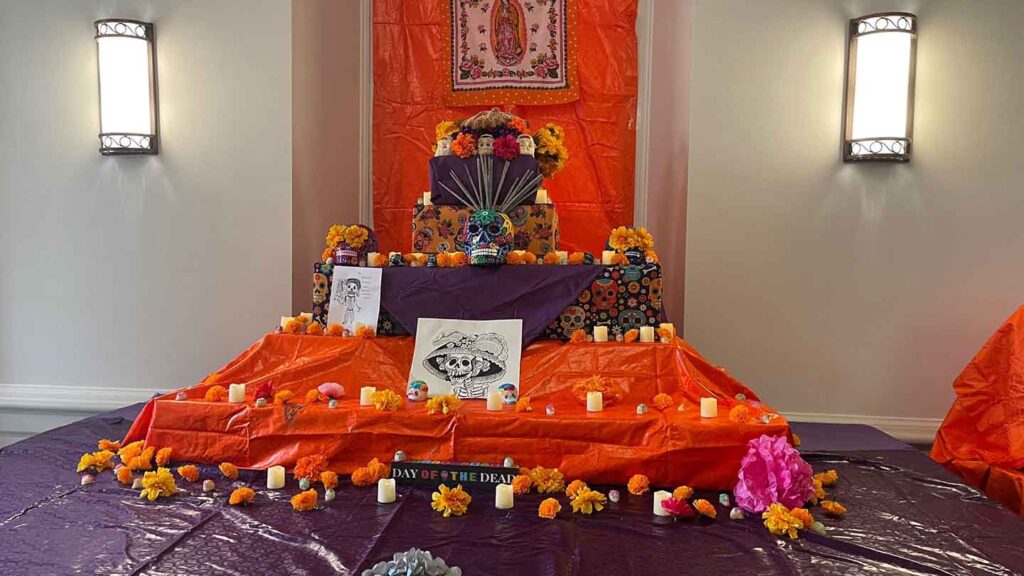 An ofrenda is set up for Day of the Dead. This traditional altar is decorated with marigolds , candles, and mementos of departed loved ones.