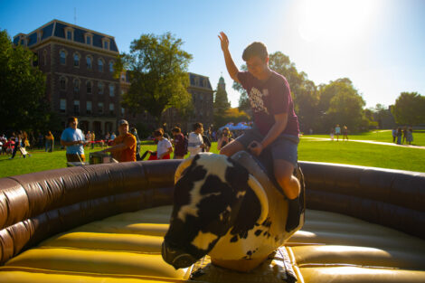 A boy rides the mechanical bull during Latinx Fest.