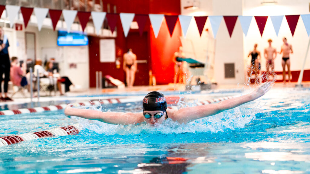 A Lafayette student athlete swimming down a lane in the Weinstein Natatorium.