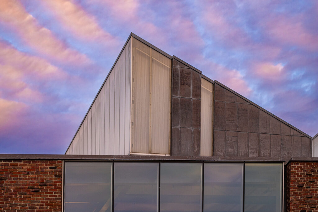 A close up shot of the geometric architecture of the Williams Visual Arts Building at dusk. 