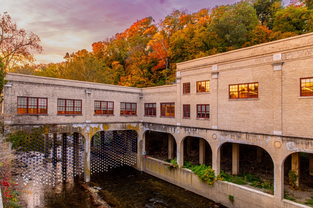 A side view of Building 248 alongside the Bushkill Creek on a vibrant fall day. 