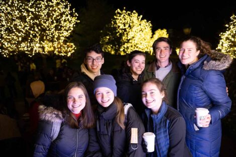 A group of students holds cocoa on the Quad during the 2022 Quad Lighting.