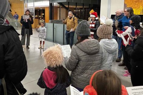 A group of kids and adults sang during Las Posadas at the library.