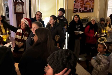 A group of carolers sings inside the President's House.