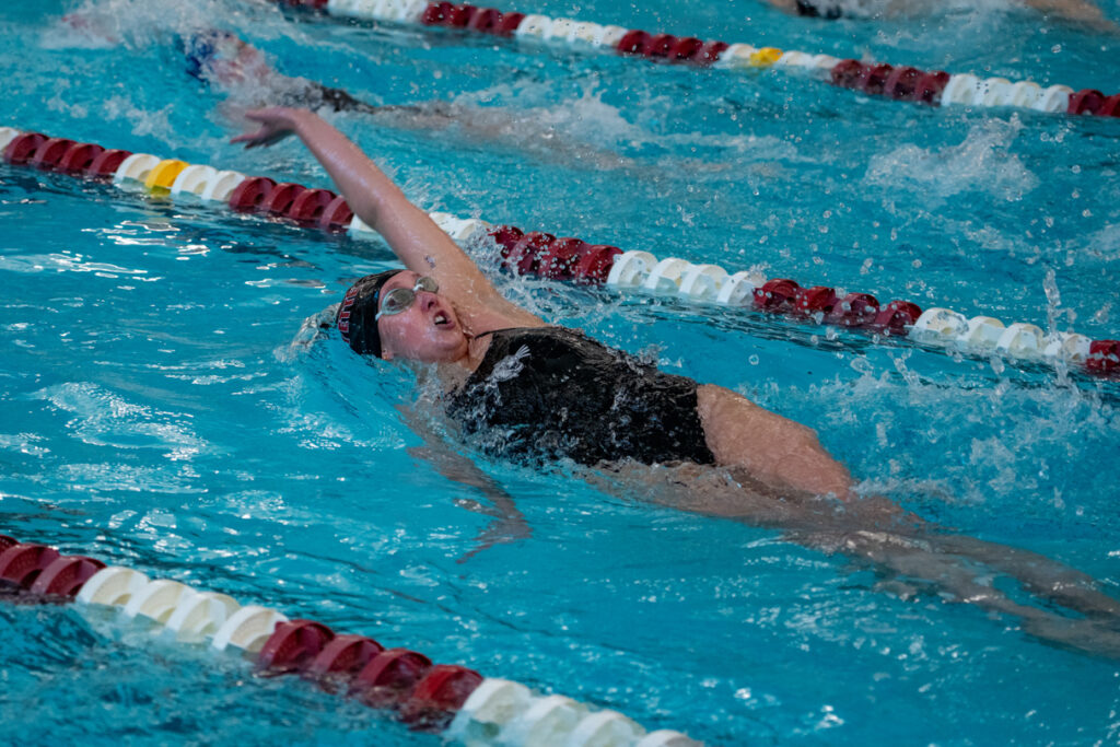 A Lafayette student athlete swims the backstroke.