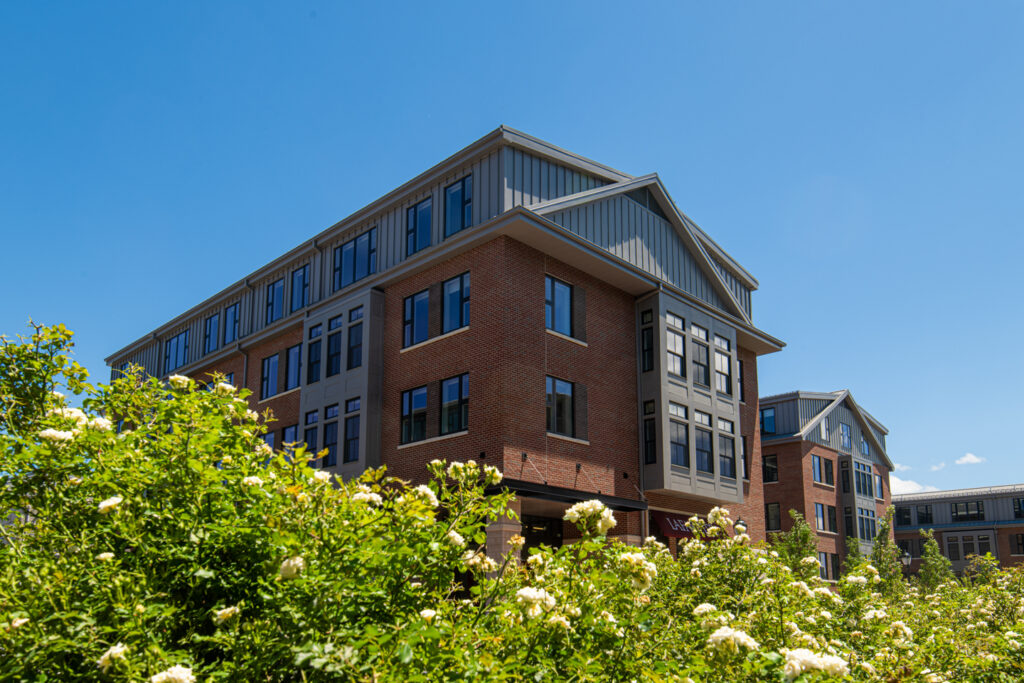 The corner of McCartney Residences with greenery in the foreground. 