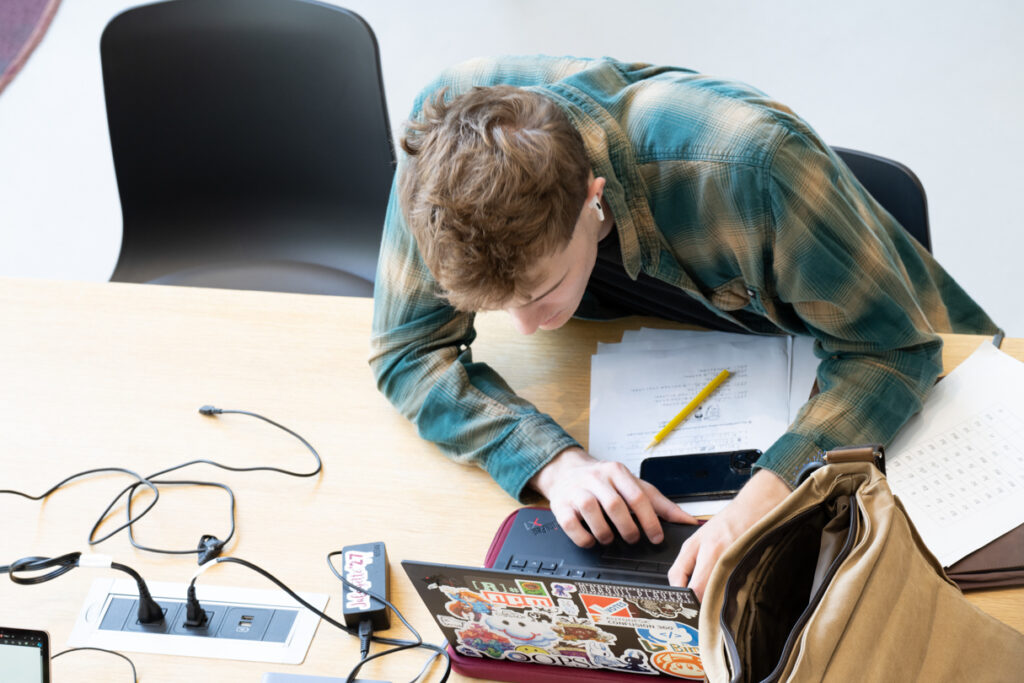 Aerial of a student working on a laptop.